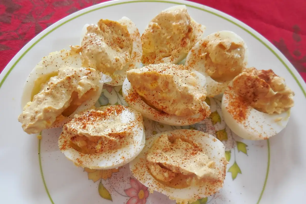 A plate of deviled eggs dusted with paprika