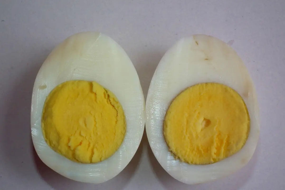 Hard boiled egg cut in half lengthwise, showing a fully set yellow yolk